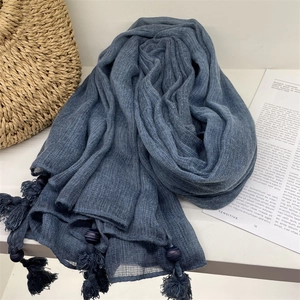 Detailed shot of blue voile scarf with handmade tassels and wood beads for travel