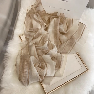 Detail of silk wool scarf showing vertical metallic stripes on soft champagne fabric