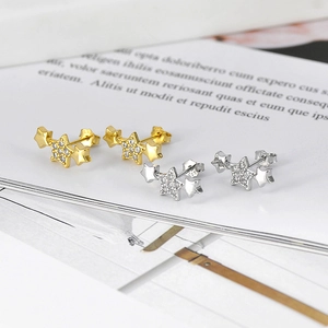 Macro shot of gold and silver star earrings with micro-inlaid zircons and S925 hallmark