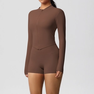 Detail of chocolate brown yoga set showing high-waist shorts and V-cut zip top