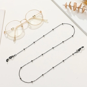 Detailed close-up of a black beaded metal eyeglass chain with rubber anti-slip loops