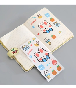Detail view of a cute rabbit cartoon notebook with magnetic clasp and matching PVC stickers