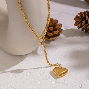 Detailed view of Baroque pearl and gold heart pendant on a stylish Y-shaped necklace