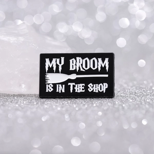 Magic witch black enamel pin with My Broom is in the Shop quote and broom design