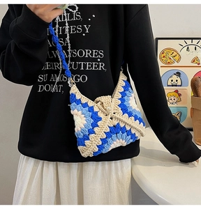 Detailed close-up of handmade crochet sunflower bag with dual pearl and woven straps
