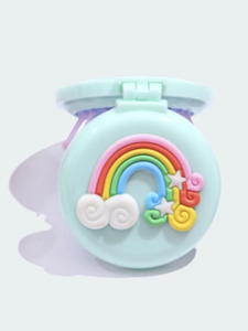 Close-up of light blue portable folding mirror comb with cute 3D rainbow and stars