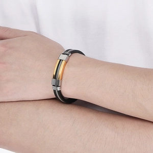 Close-up of men's silicone and stainless steel bracelet with Greek key pattern on model