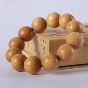 Macro detail of 20mm Indonesian bodhi wood beads showing natural grain and oily texture
