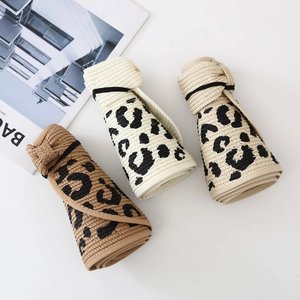Rollable leopard print straw sun hats with bow closure in three colors shown from top view