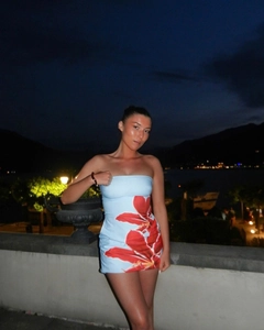 Detail of blue tube dress with red floral print and slim fit bodycon silhouette