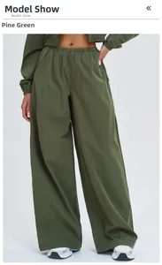 Detail of pine green high-waisted wide-leg joggers with side pockets and elastic waist