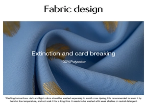 Macro detail of blue polyester fabric featuring golden feather patterns and fabric care label