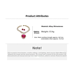 Detail view of pink heart pendant necklace and earrings set with alloy rhinestone pave