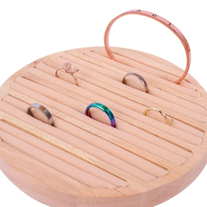 Solid wood circular jewelry display stand with beige velvet slots for rings and bracelets