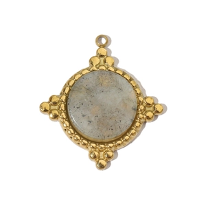 Detailed macro view of a vintage gold-plated celestial star pendant with natural grey stone