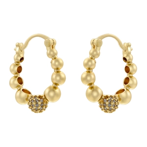 Detailed close-up of golden beaded hoop earrings with pavé-set white zircon ball drop
