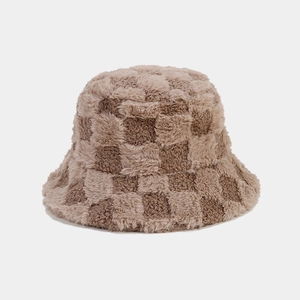 Close-up of soft plush checkerboard bucket hat with thick faux fur texture details