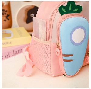 Close-up of pink toddler backpack side mesh pocket with ruler for size reference