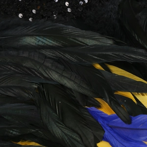 Macro detail of elegant feather trim with black sequins on long sleeve formal gown