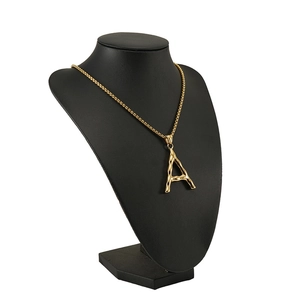 Close-up of 18K gold letter A pendant with textured finish on box chain display