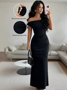 Detail of elegant gold metal shoulder accessories and double-layer folding on black dress