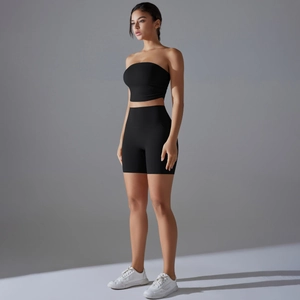 Women's black seamless ribbed fitness set with crop tube top and high waist biker shorts