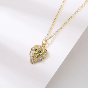 18K gold plated lion head pendant necklace with sparkling cubic zirconia on white display
