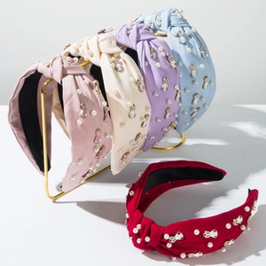Detail of colorful knotted fabric headbands with Easter bunny charms and pearls