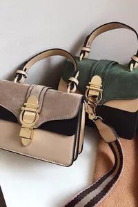 Detail view of contrast matte crossbody bags with gold round locks and striped straps