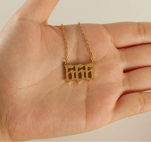 Detailed view of gold 666 lucky number pendant necklace with sandblasted glitter finish