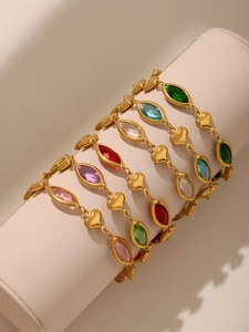 Detail of colorful heart bracelets with marquise stones on a cylindrical jewelry display stand