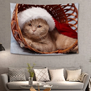 Detailed view of Christmas tapestry featuring an orange cat in a basket on a grey wall