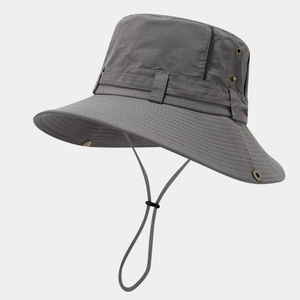 Detail of dark grey sun hat featuring metal ventilation eyelets and adjustable wind cord