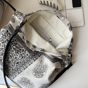 Vintage boho canvas tote bag with black paisley patterns and magnetic snap closure