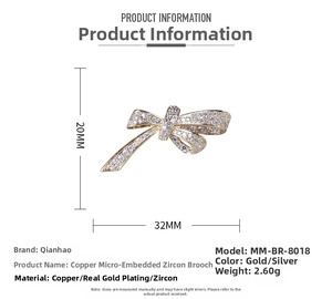Macro detail of bow brooch made of copper with cubic zirconia and gold plating