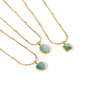 Golden bead chain necklaces featuring heart and geometric blue cat eye stone pendants