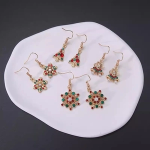 Christmas earrings set with snowflakes, trees and bells in gold finish and rhinestones