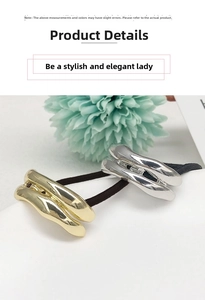 Detailed view of U-shaped gold and silver metal charms on black elastic hair ties