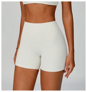 Close-up of white ribbed high-waist fitness shorts showing premium knit texture