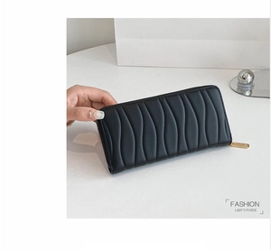 Close-up of black PU leather long purse with wave texture and gold zipper detail