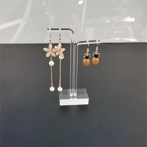 Acrylic jewelry display set with pearl flower earrings and pineapple shaped dangles