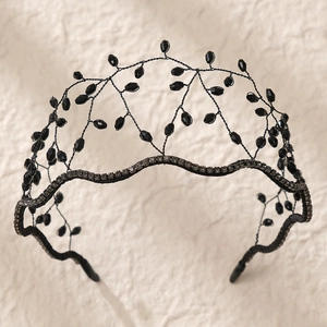 Close-up of handmade black beaded crown headband with dark crystals and wired details