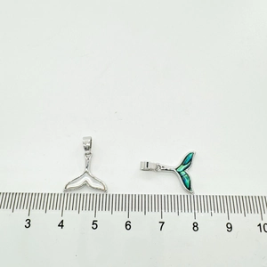 18K gold-plated whale tail pendants with shell inlays next to a measurement ruler