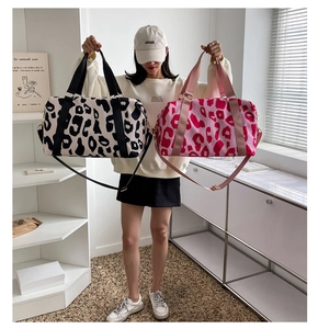 Dual cow print travel bags in black and pink featuring wet dry separation compartments