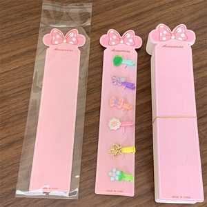 Detailed view of pink Minnie-style hair clip display cards with six colorful plastic clips