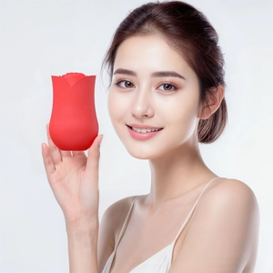 Close-up of a red rose shaped silicone facial massager with embossed max logo detail
