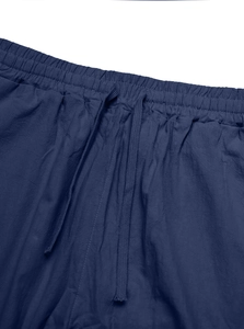 Detail of navy blue linen trousers showing elastic waistband and woven drawstring