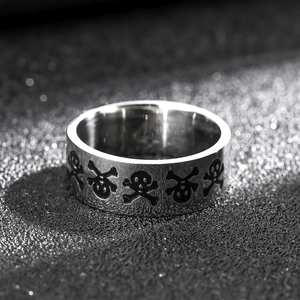 8mm silver titanium steel ring with black skull engraving on a brushed metal finish