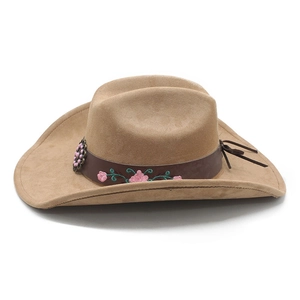 Close-up of camel suede cowboy hat with brown leather band and floral embroidery details