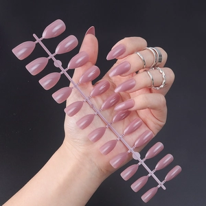 Glossy dusty rose pointed press-on nails set shown on a model hand with various sizes